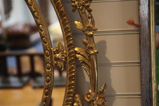 A Victorian oval gilt wall mirror, 4ft 11in. x 2ft 9.5in.